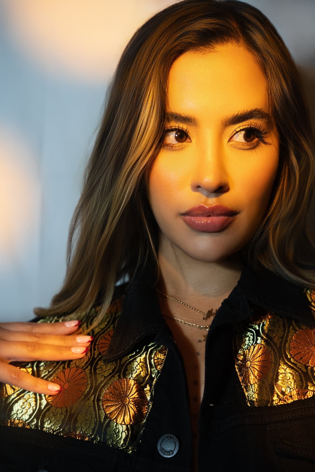 Model wearing a hand painted SarArt jacket in an urban setting