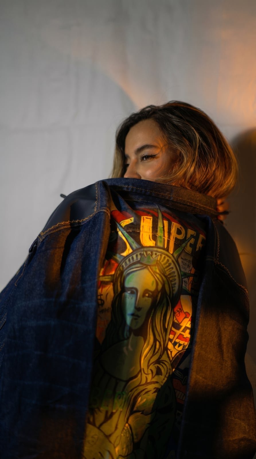 Model wearing a hand painted SarArt jacket in an urban setting
