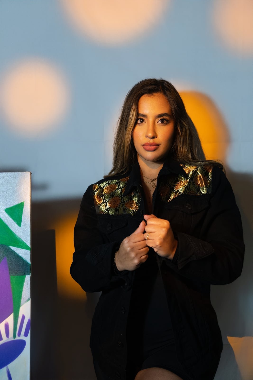 Model wearing a hand painted SarArt jacket in an urban setting